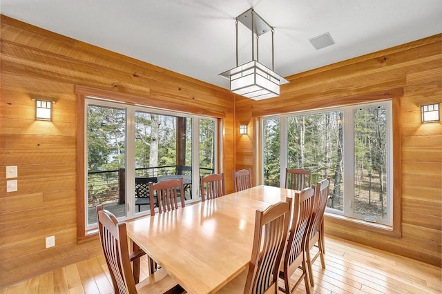 3857 Lake Lucerne Dr, Crandon, WI 54520 - dining area featuring wooden walls and light wood-type flooring