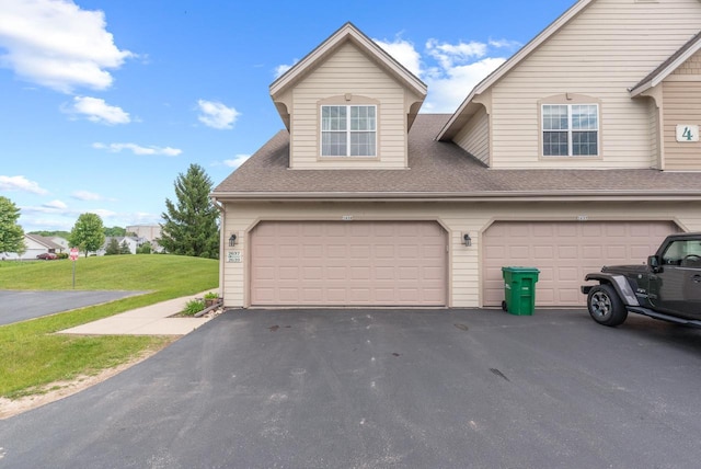 2639 W Honadel Blvd, Oak Creek, WI 53154 - view of front of property featuring a front lawn, driveway, roof with shingles, and an attached garage