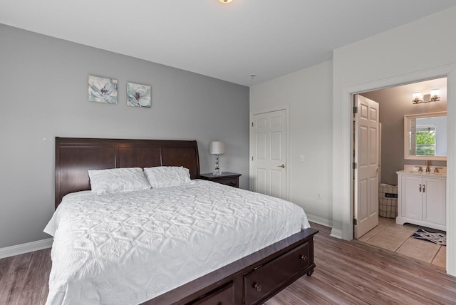 2639 W Honadel Blvd, Oak Creek, WI 53154 - bedroom featuring light wood-style floors and connected bathroom