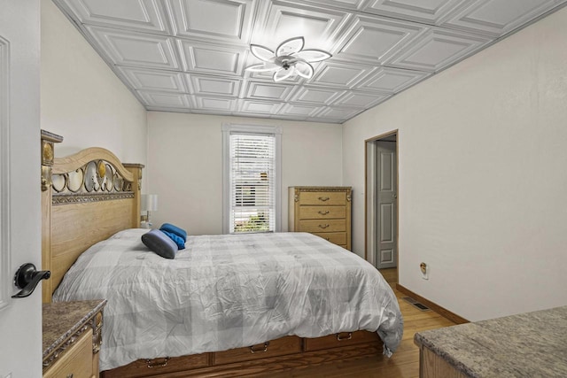 547 Eureka St, Ripon, WI 54971 - bedroom with an ornate ceiling, light wood-style floors, and baseboards