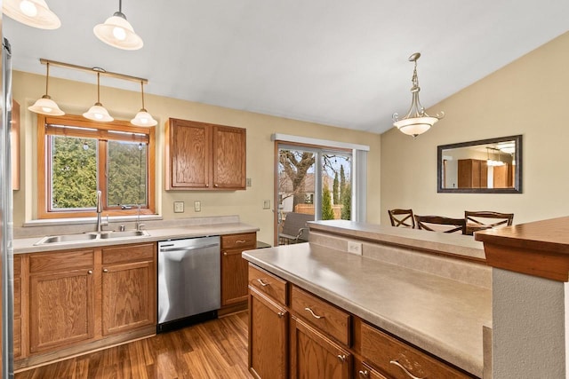 7338 Blue Maple Trl, Madison, WI 53719 - kitchen featuring stainless steel dishwasher, a sink, dark wood-style flooring, lofted ceiling, and hanging light fixtures