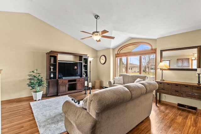 7338 Blue Maple Trl, Madison, WI 53719 - living area featuring a ceiling fan, vaulted ceiling, wood finished floors, and baseboards