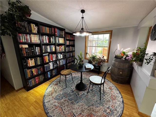 1311 W Northstar Ln, Eau Claire, WI 54703 - home office featuring bookshelves, a textured ceiling, wood finished floors, crown molding, and lofted ceiling