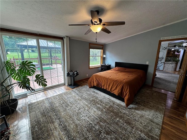 1311 W Northstar Ln, Eau Claire, WI 54703 - bedroom featuring access to exterior, a textured ceiling, ornamental molding, ceiling fan, and wood finished floors