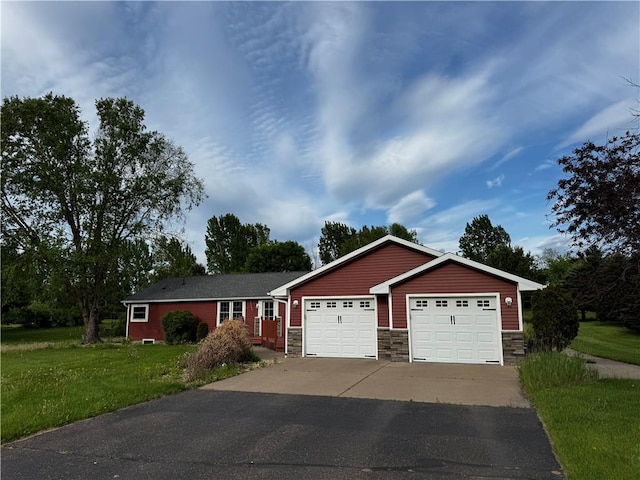 1311 W Northstar Ln, Eau Claire, WI 54703 - ranch-style house with stone siding, a front yard, and driveway