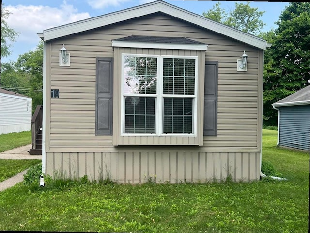 N2639 County Road Z Unit B19, Dousman, WI 53118 - view of home's exterior featuring a lawn