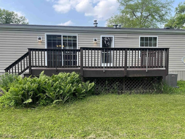 N2639 County Road Z Unit B19, Dousman, WI 53118 - rear view of house featuring a deck, a yard, and cooling unit