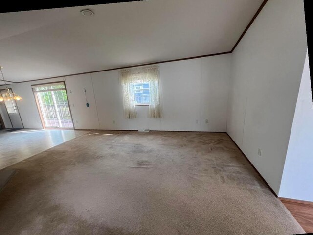 N2639 County Road Z Unit B19, Dousman, WI 53118 - unfurnished room featuring light colored carpet and a chandelier