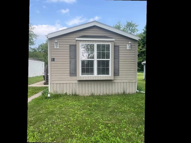 N2639 County Road Z Unit B19, Dousman, WI 53118 - view of side of home with a yard