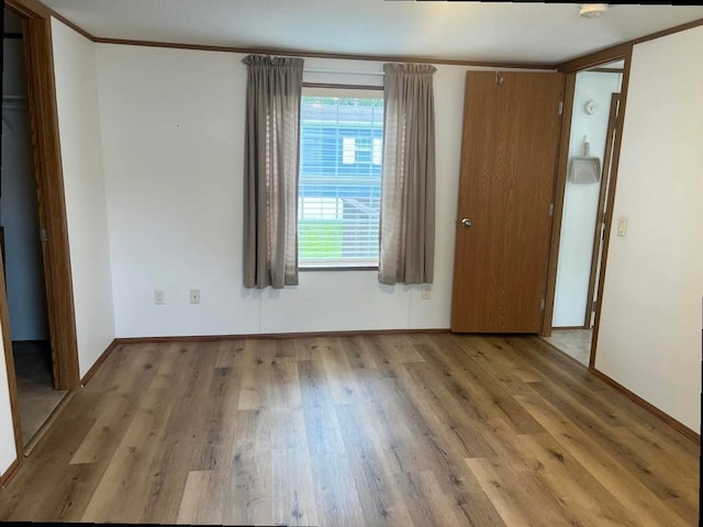 N2639 County Road Z Unit B19, Dousman, WI 53118 - unfurnished bedroom featuring wood finished floors and baseboards