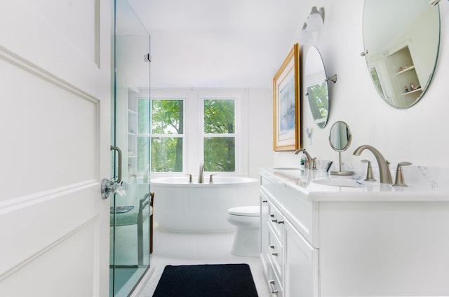 W347N6122 Rd I, Oconomowoc, WI 53066 - bathroom featuring double vanity, a freestanding tub, toilet, and a shower with shower door