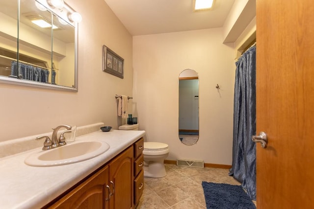 1207 Lark St, Merrill, WI 54452 - full bathroom with vanity, toilet, a shower with curtain, tile patterned floors, and baseboards