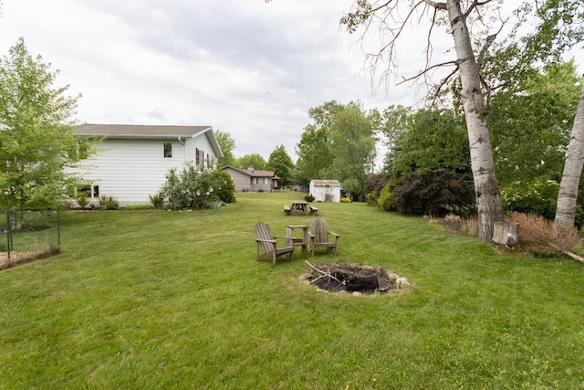 1207 Lark St, Merrill, WI 54452 - view of grassy yard with a fire pit and an outdoor structure