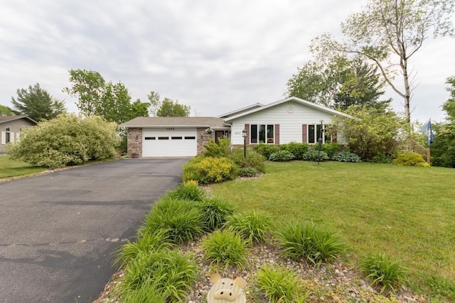 1207 Lark St, Merrill, WI 54452 - ranch-style home with a garage, asphalt driveway, and a front lawn