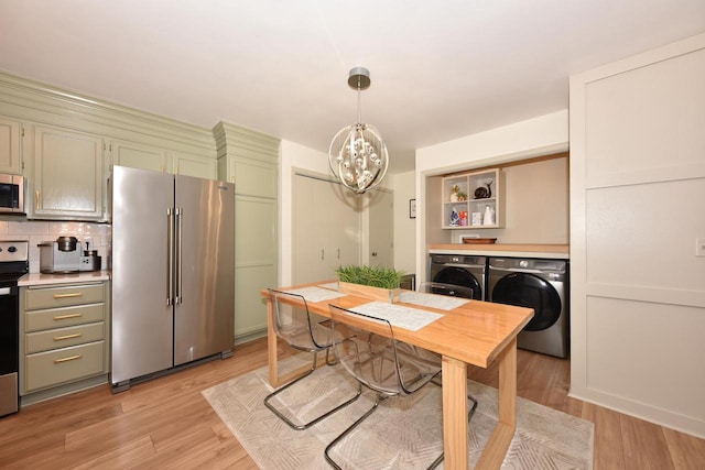 724 Worthington Ct Unit 3-A, West Bend, WI 53090 - dining room with a chandelier, washing machine and clothes dryer, light wood-type flooring, and an office area