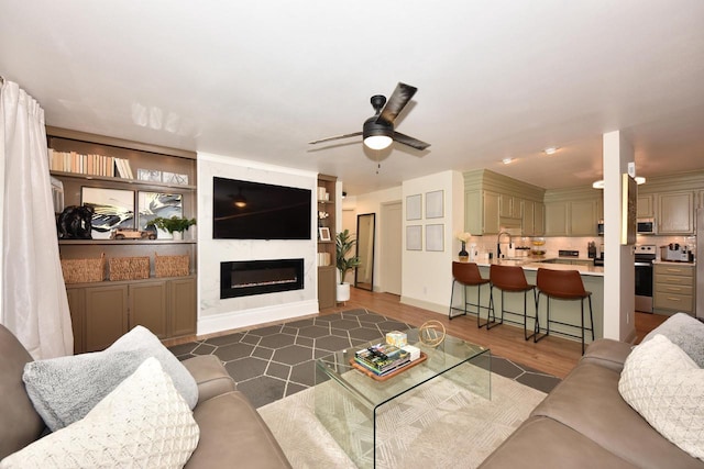 724 Worthington Ct Unit 3-A, West Bend, WI 53090 - living room with a ceiling fan, a fireplace, and dark wood-type flooring
