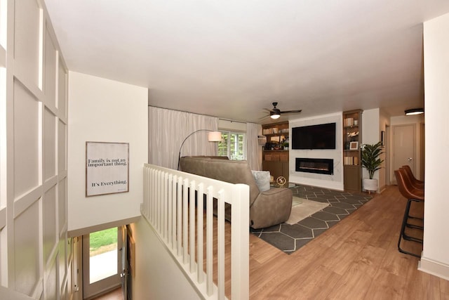 724 Worthington Ct Unit 3-A, West Bend, WI 53090 - living area featuring ceiling fan, wood finished floors, and a glass covered fireplace