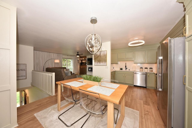 724 Worthington Ct Unit 3-A, West Bend, WI 53090 - dining area featuring light wood-style floors, a chandelier, and ceiling fan
