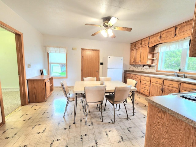 5609 Two Creeks Rd, Two Rivers, WI 54241 - dining space featuring light flooring, ceiling fan, and baseboards