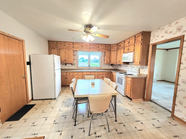 5609 Two Creeks Rd, Two Rivers, WI 54241 - kitchen with white appliances, a sink, light flooring, and ceiling fan