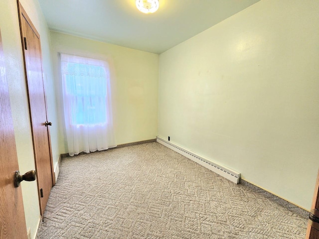 5609 Two Creeks Rd, Two Rivers, WI 54241 - unfurnished room featuring a baseboard radiator, light carpet, and baseboards