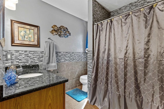 831 Browning Dr, Seymour, WI 54165 - bathroom featuring tile patterned flooring, vanity, tile walls, toilet, and a wainscoted wall