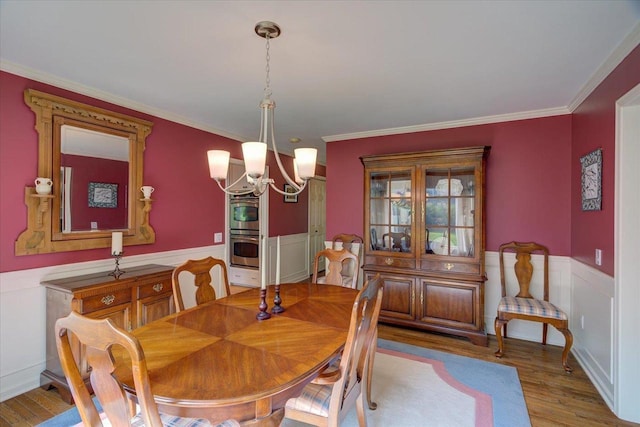 101 Everglade Dr, Madison, WI 53717 - dining space featuring wood finished floors, a wainscoted wall, a chandelier, and ornamental molding