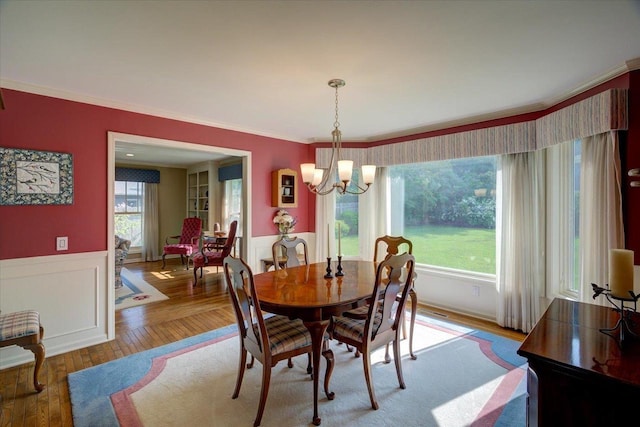 101 Everglade Dr, Madison, WI 53717 - dining area featuring a wainscoted wall, a chandelier, crown molding, and wood finished floors