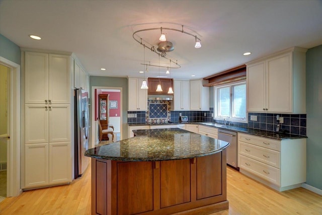 101 Everglade Dr, Madison, WI 53717 - kitchen with stainless steel appliances, light wood-style floors, a center island, tasteful backsplash, and recessed lighting
