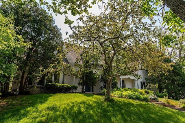 101 Everglade Dr, Madison, WI 53717 - obstructed view of property featuring a front lawn and brick siding