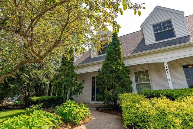 101 Everglade Dr, Madison, WI 53717 - property entrance with brick siding, covered porch, and a shingled roof