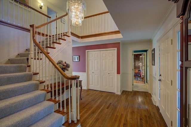 101 Everglade Dr, Madison, WI 53717 - entryway featuring hardwood / wood-style floors, stairway, a wainscoted wall, a chandelier, and ornamental molding