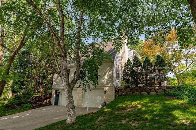 101 Everglade Dr, Madison, WI 53717 - view of property exterior with driveway, an attached garage, a lawn, a chimney, and brick siding