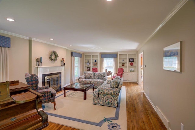 101 Everglade Dr, Madison, WI 53717 - living room with a tile fireplace, wood finished floors, crown molding, baseboards, and recessed lighting