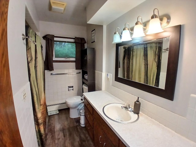 2048 County Road Q, Pound, WI 54161 - full bathroom with wood finished floors, vanity, toilet, tile walls, and a shower with shower curtain