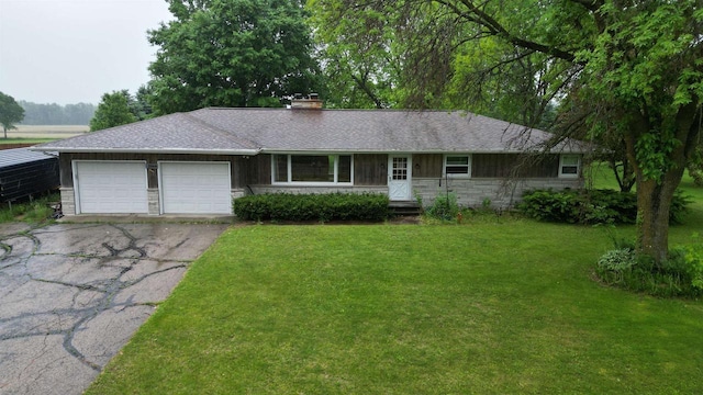 2048 County Road Q, Pound, WI 54161 - single story home with asphalt driveway, a garage, stone siding, a front lawn, and a chimney