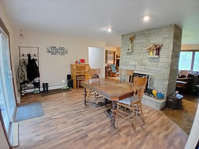 2048 County Road Q, Pound, WI 54161 - dining space with wood finished floors, a stone fireplace, and baseboards