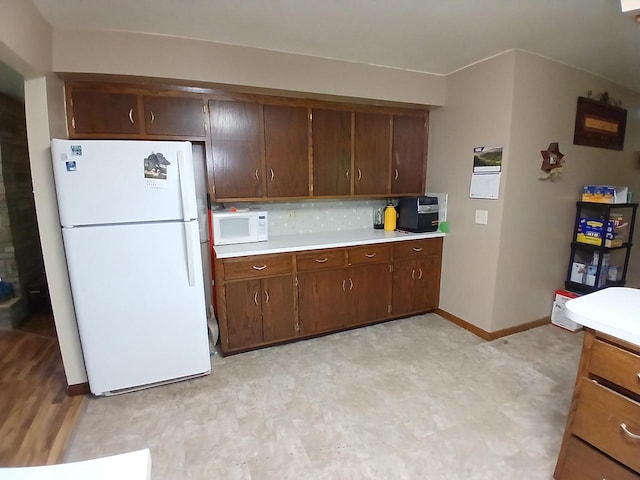 2048 County Road Q, Pound, WI 54161 - kitchen with white appliances, light countertops, light floors, and baseboards