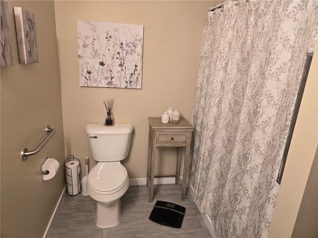 318 Frenette Dr Unit 2, Chippewa Falls, WI 54729 - bathroom with toilet, baseboards, wood finished floors, and curtained shower