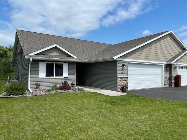 4010 Nicholas Dr, Menomonie, WI 54751 - view of front of home with an attached garage, asphalt driveway, a front lawn, and roof with shingles