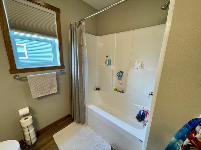4010 Nicholas Dr, Menomonie, WI 54751 - full bathroom with shower / bath combo, wood finished floors, toilet, and baseboards