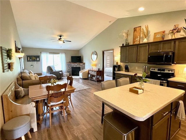 4010 Nicholas Dr, Menomonie, WI 54751 - kitchen with stainless steel appliances, a ceiling fan, dark wood-style flooring, light countertops, and vaulted ceiling