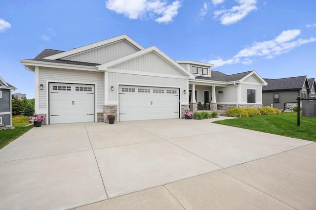 6249 Fountainhead Cir, Deforest, WI 53532 - craftsman-style home with stone siding, board and batten siding, a garage, and a front yard