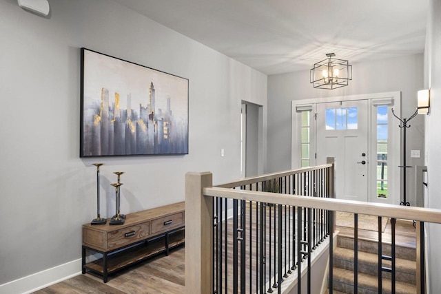 6249 Fountainhead Cir, Deforest, WI 53532 - entrance foyer with wood finished floors, baseboards, and a chandelier