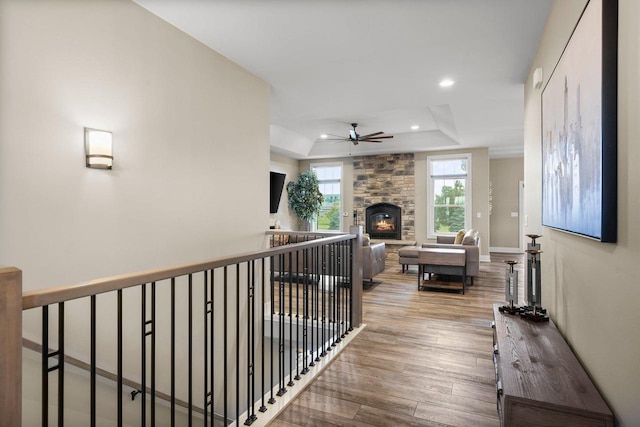 6249 Fountainhead Cir, Deforest, WI 53532 - hallway featuring a raised ceiling, wood finished floors, recessed lighting, and baseboards