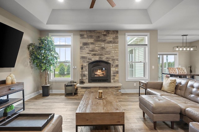 6249 Fountainhead Cir, Deforest, WI 53532 - living area featuring a raised ceiling, hardwood / wood-style floors, plenty of natural light, and a fireplace