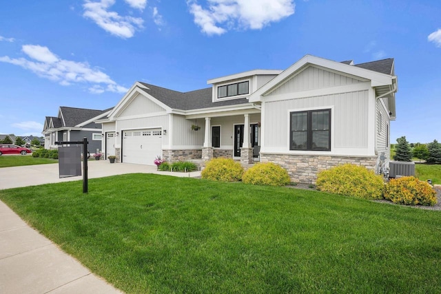 6249 Fountainhead Cir, Deforest, WI 53532 - view of front of home featuring stone siding, a front yard, concrete driveway, and an attached garage