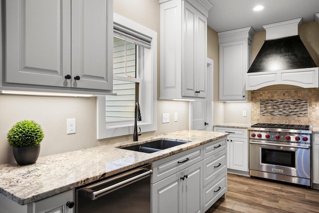 6249 Fountainhead Cir, Deforest, WI 53532 - kitchen featuring dishwasher, luxury stove, a sink, premium range hood, and backsplash