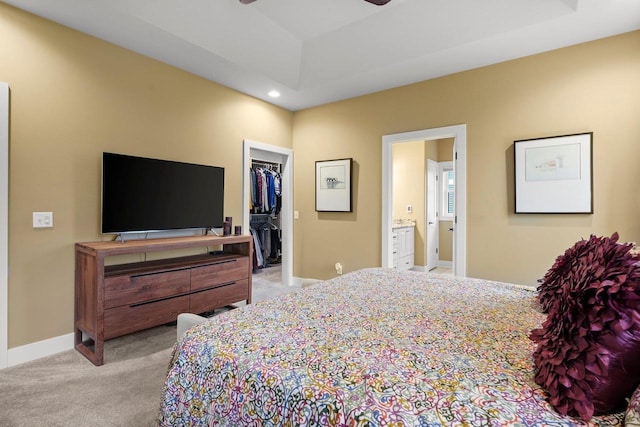 6249 Fountainhead Cir, Deforest, WI 53532 - bedroom with light colored carpet, recessed lighting, a walk in closet, connected bathroom, and baseboards