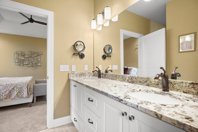 6249 Fountainhead Cir, Deforest, WI 53532 - ensuite bathroom with ceiling fan, double vanity, and baseboards